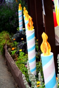 giant candles standing in garden