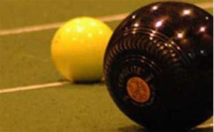 An image of a short mat bowls ball and white jack ball