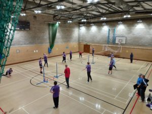 A group of badminton players play on court as part of the ActivLives Badminton tournament 2022.