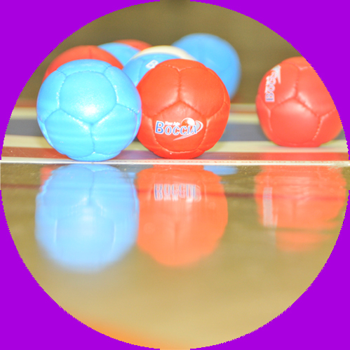 Blue and red boccia balls sits on a target
