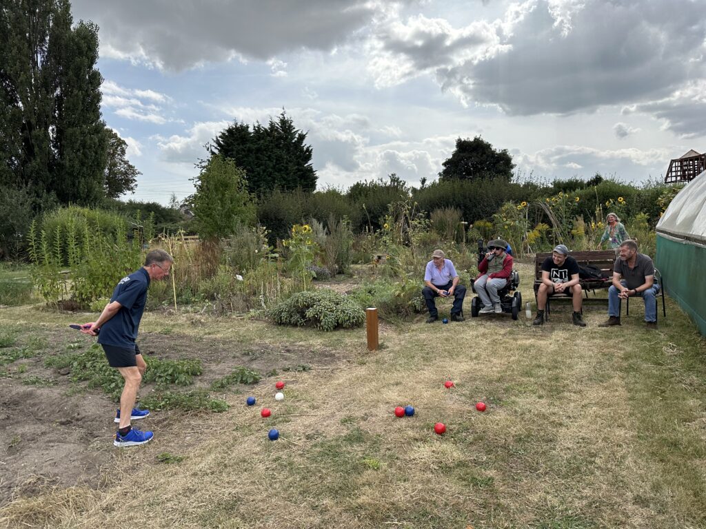 Volunteers at ActivGardens playing Boccia at the People's Community Garden open area