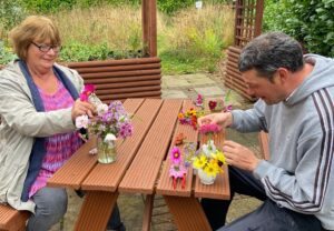 Two volunteers doing some flower arrangements