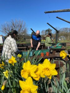 Participants of a Grow Your Future course doing some gardening activities at the community garden